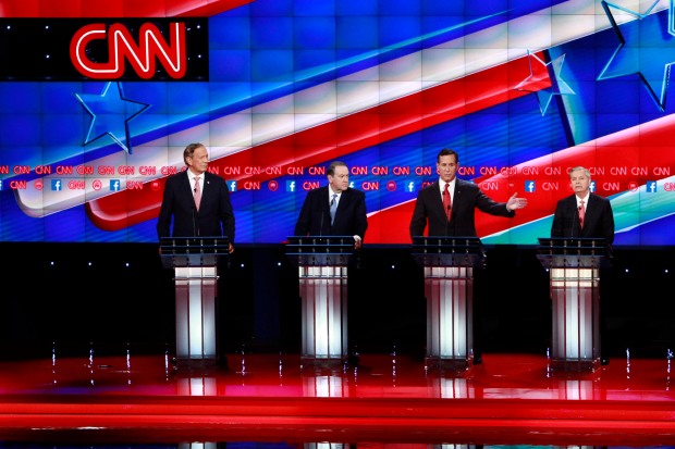 The candidates for the first debate, Governor George Pataki, Mike Huckabee, Rick Santorum and Lindsey Graham take the stage for the CNN Republican Debate in Las Vegas, Nevada at the Venetian Theater in the Venetian Hotel.